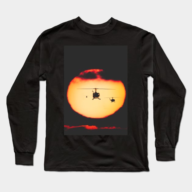 Bell Huey helicopters flying in front of the setting sun Long Sleeve T-Shirt by Pitmatic